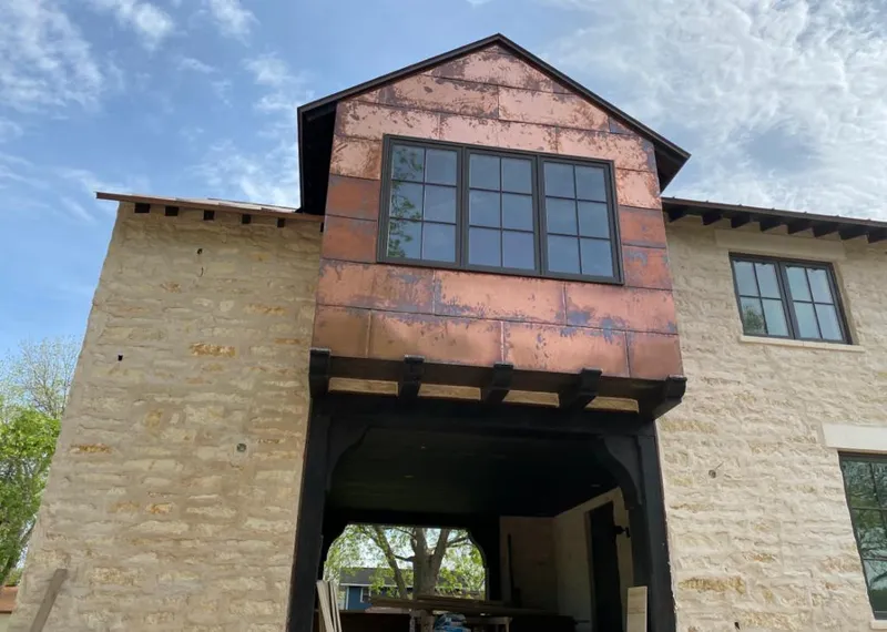 Copper metal panel facade on a stone building for Skylight Installation in Ballenger Creek